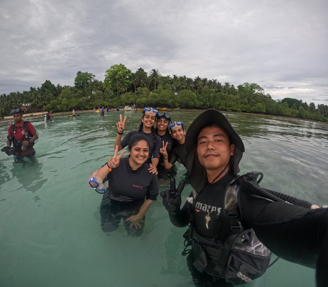 A group of divers with their Scuba India guide wading back to shore at Havelock